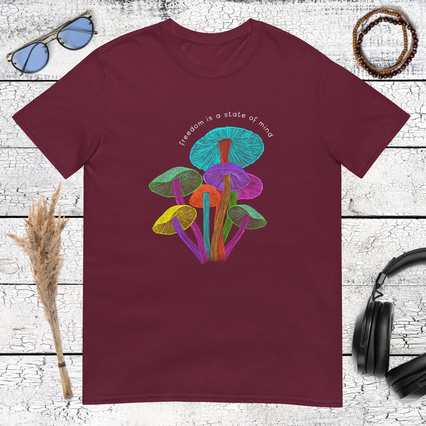 Artistic psychedelic mushroom collage with "Freedom is a state of mind" text on a maroon t-shirt