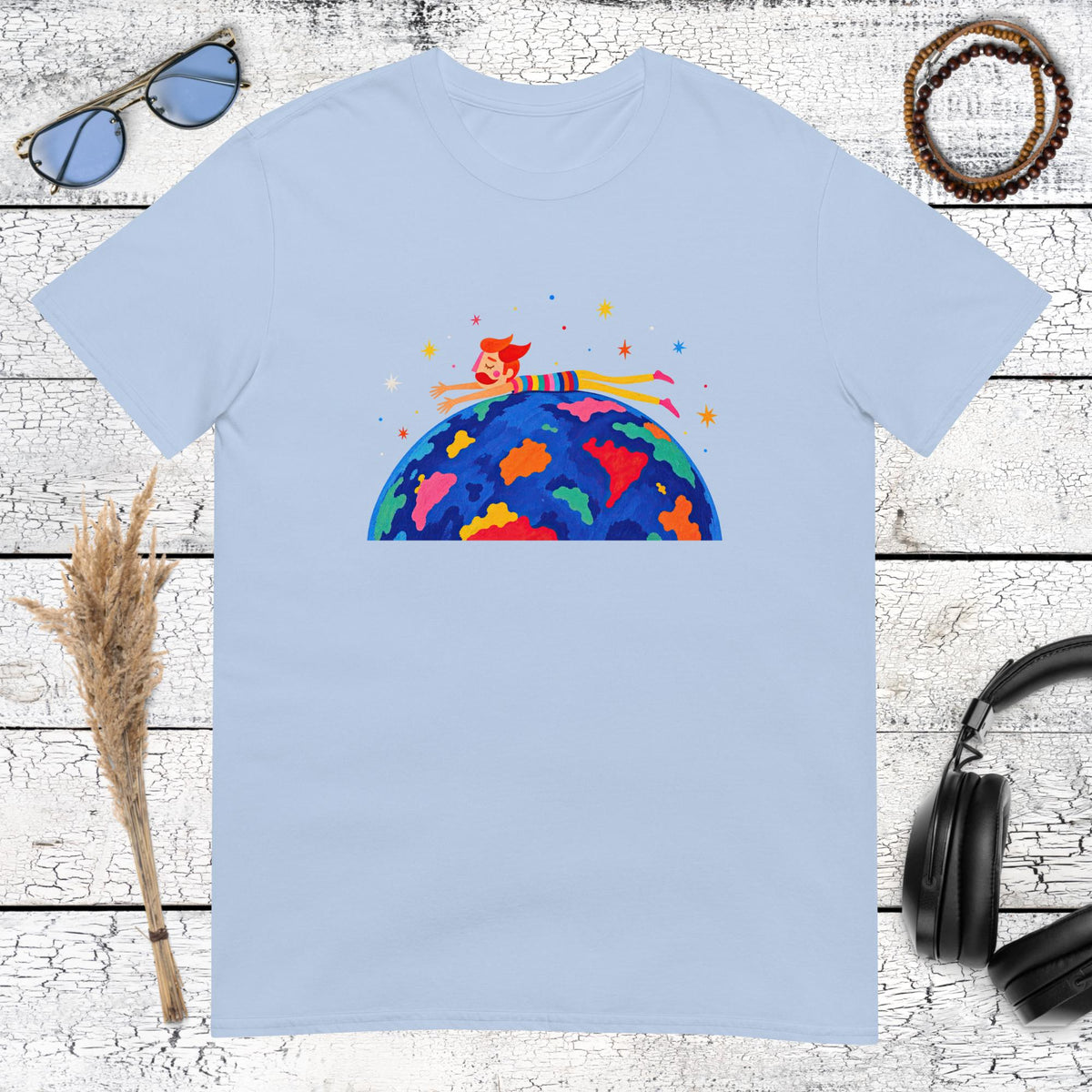 Playful cosmic traveller riding a colourful planet Earth on a light blue t-shirt
