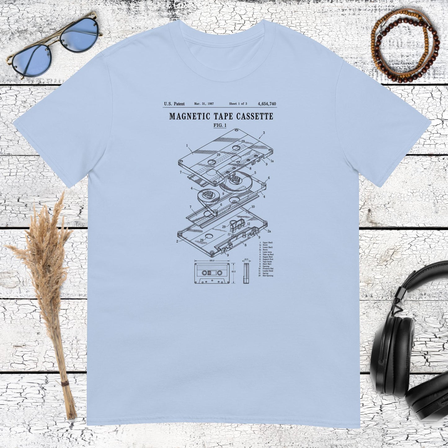 Retro magnetic tape cassette illustration printed on a light blue t-shirt