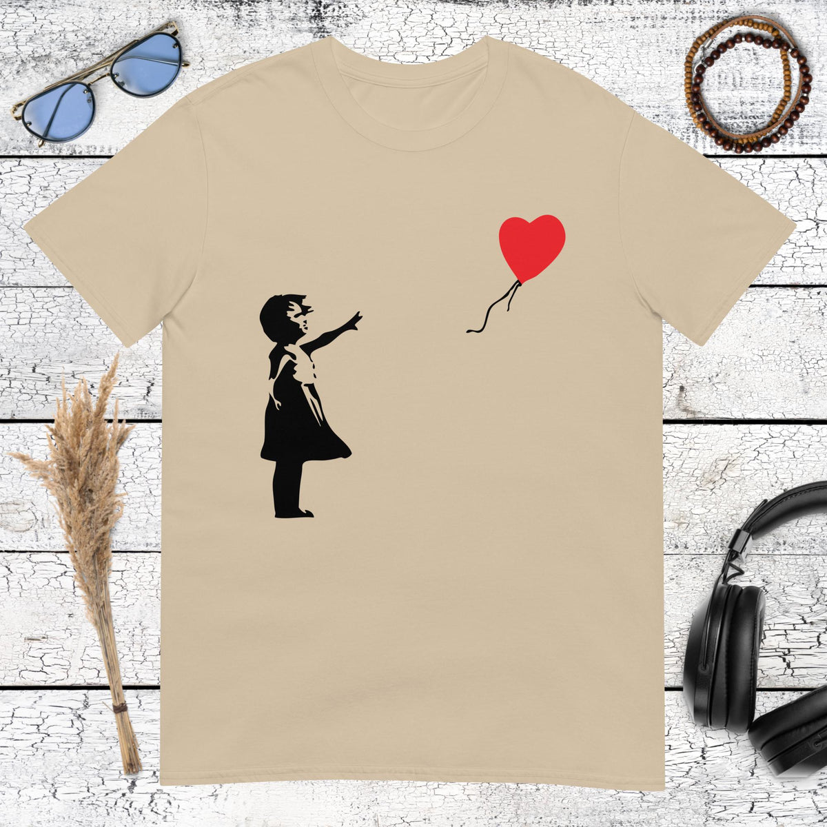 Sand colored t-shirt with retro Banksy Girl with Balloon graphic design