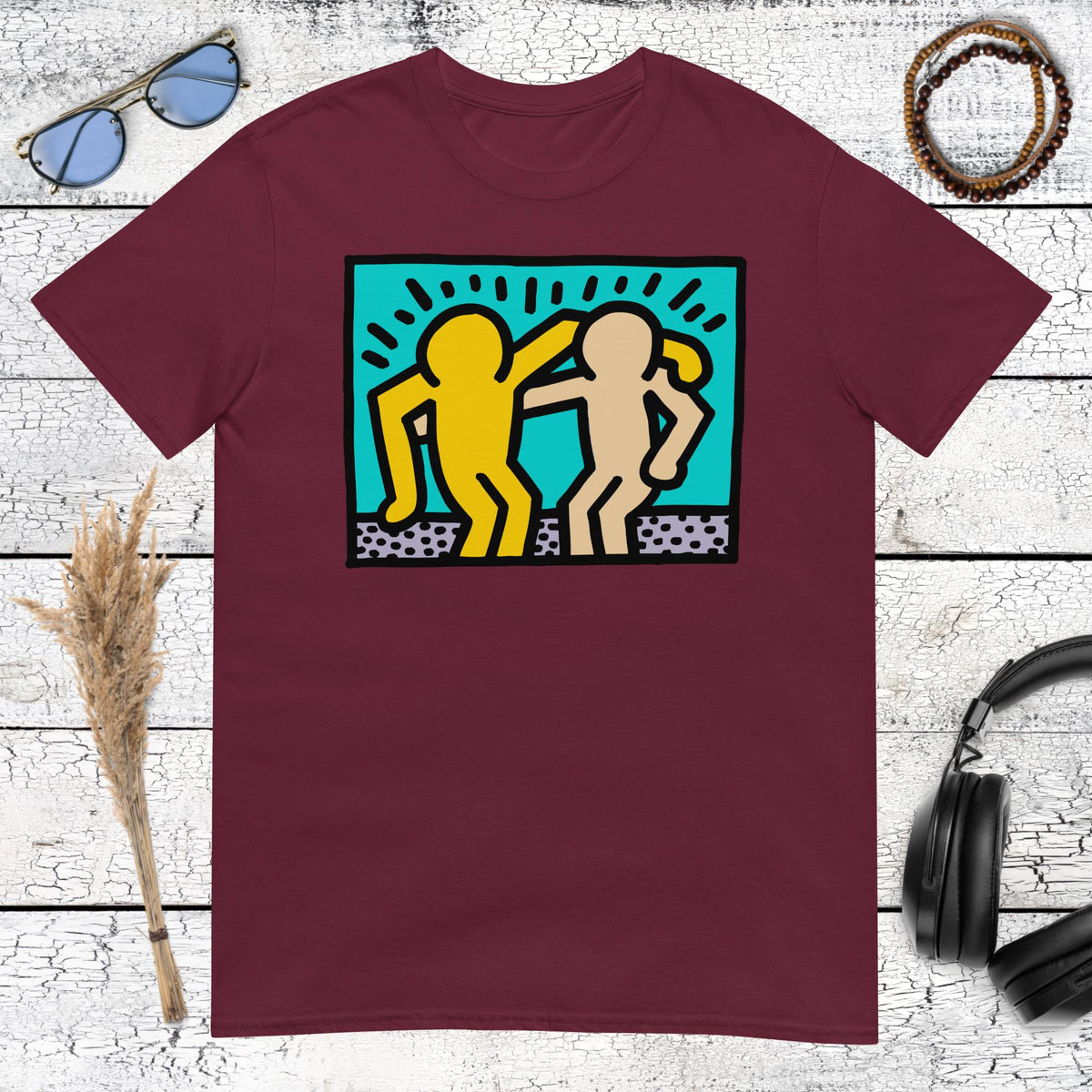 Maroon t-shirt featuring a playful Keith Haring style character collage