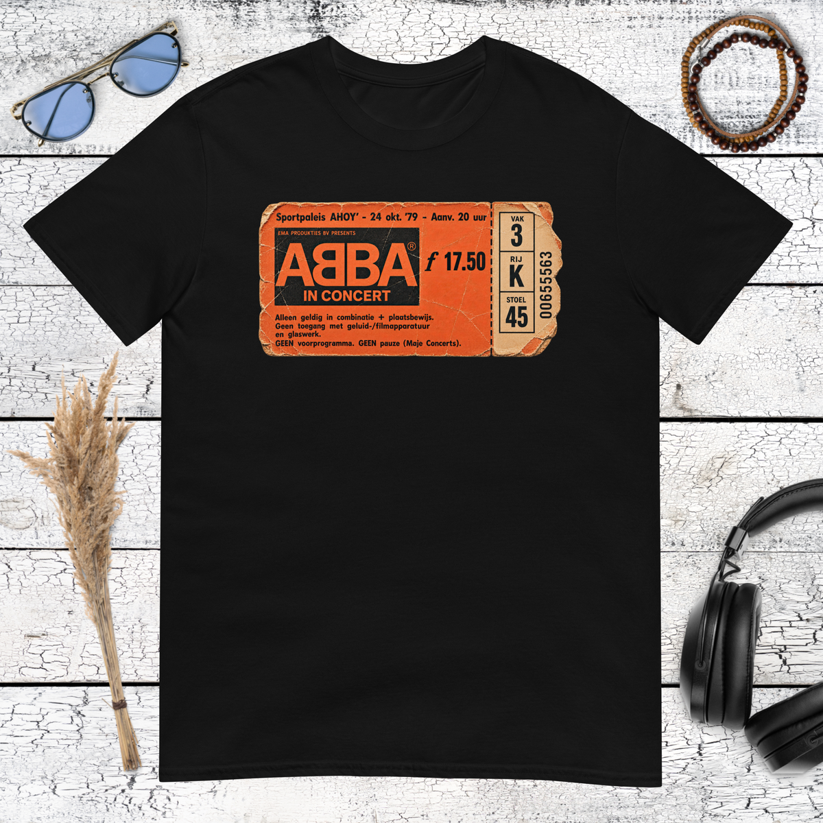 Orange ABBA logo graphic printed on a black vintage music t-shirt