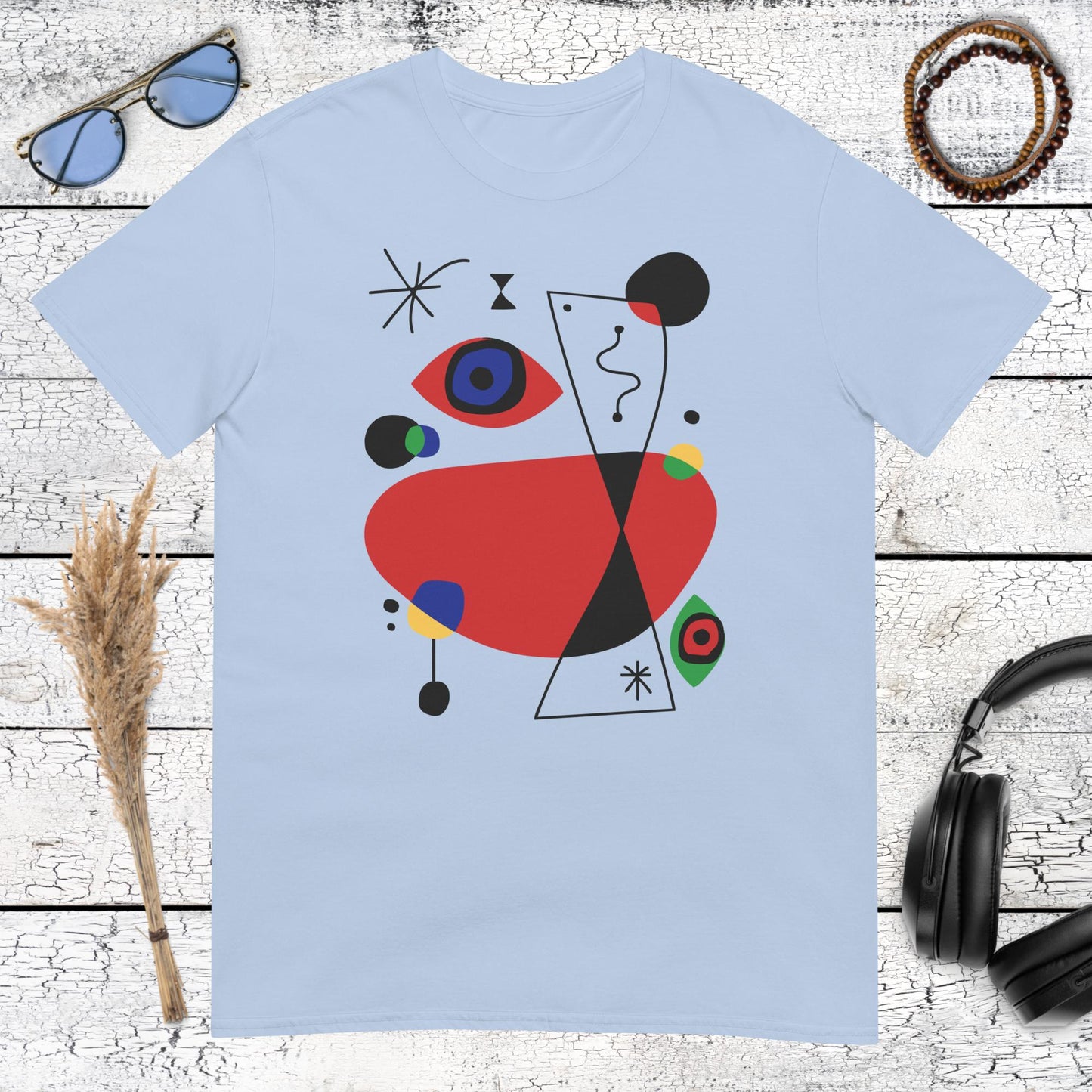 Colourful abstract artwork with geometric shapes printed on a light blue t-shirt