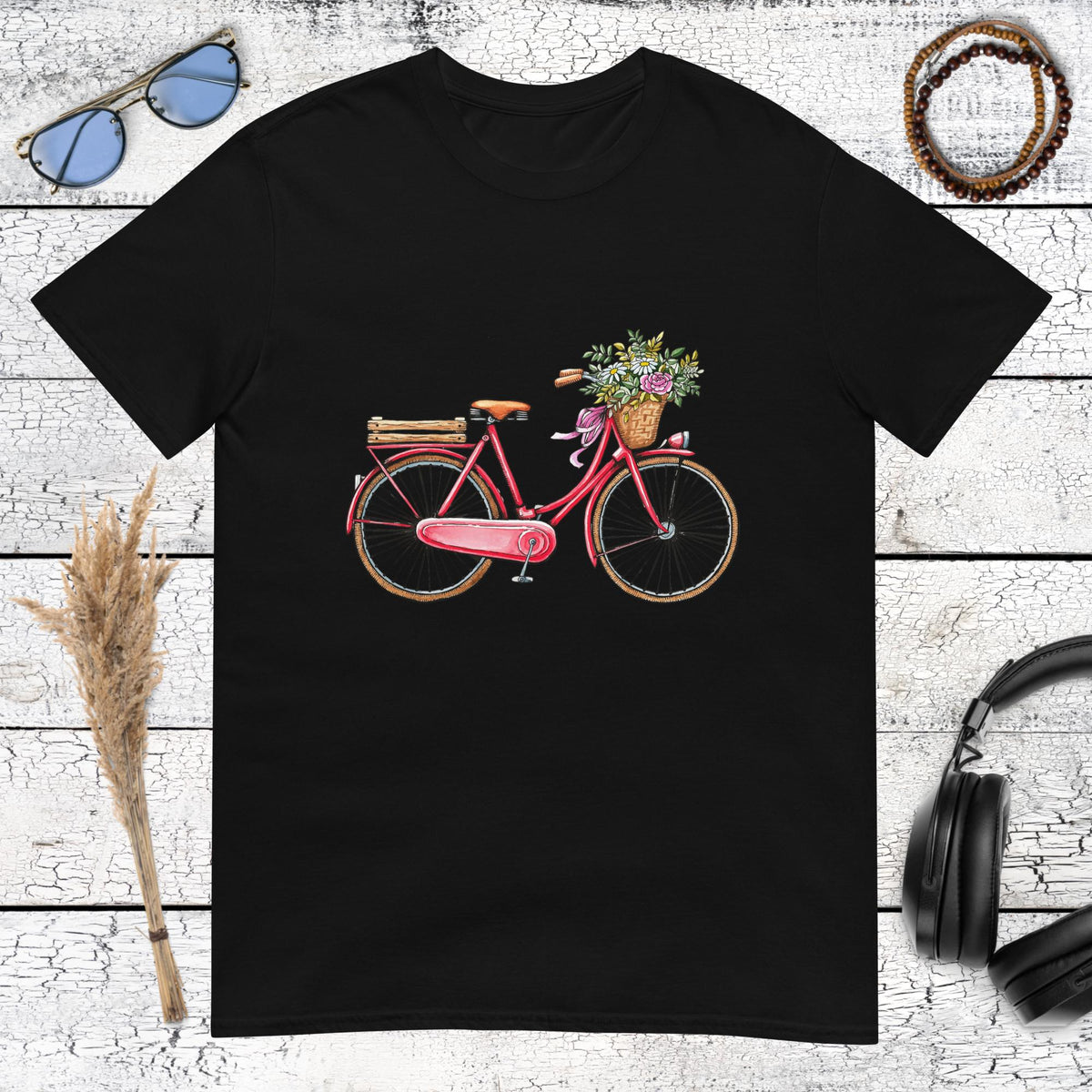 High contrast pink bicycle illustration with colorful flowers on a black t-shirt