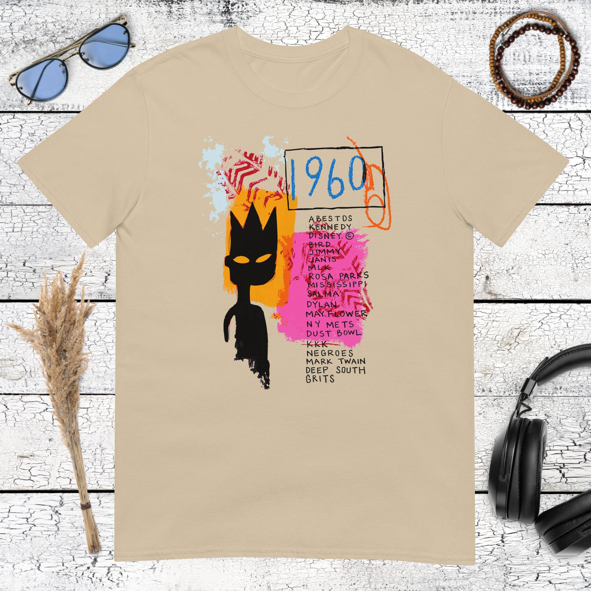 Colourful abstract portrait and crown graphic on a sand coloured t-shirt