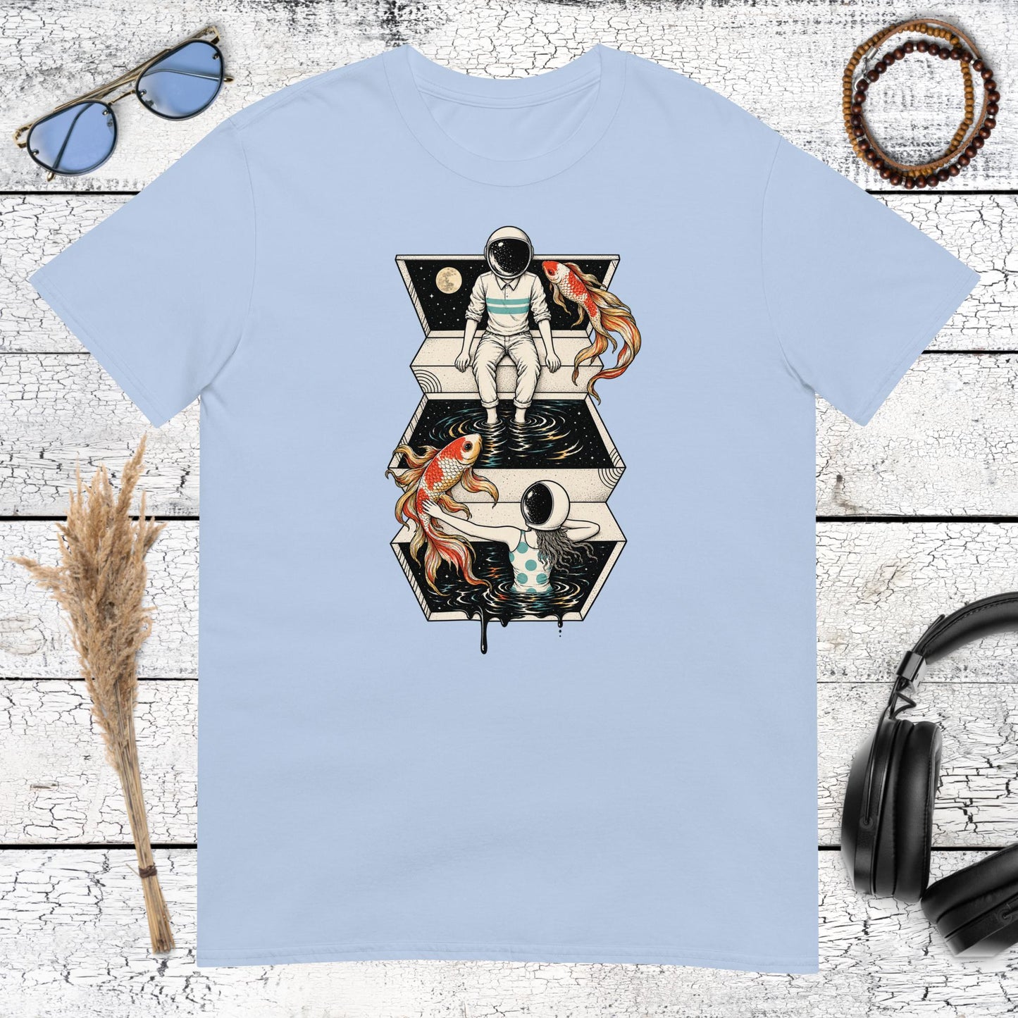 Colourful astronaut and koi fish space artwork printed on a light blue t-shirt