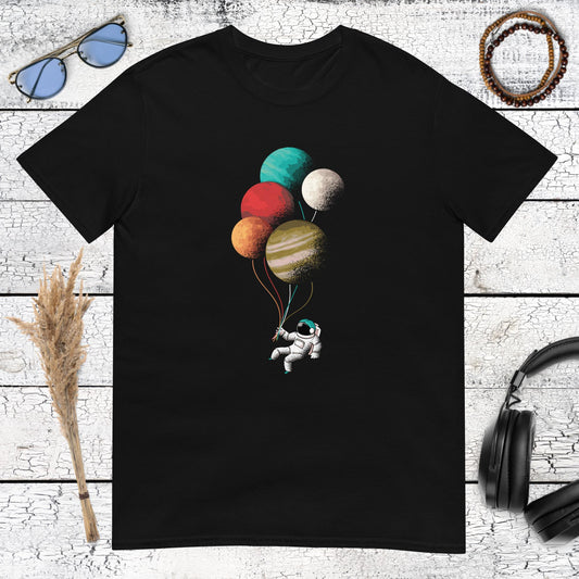 Floating astronaut holding planets like balloons on a black t-shirt