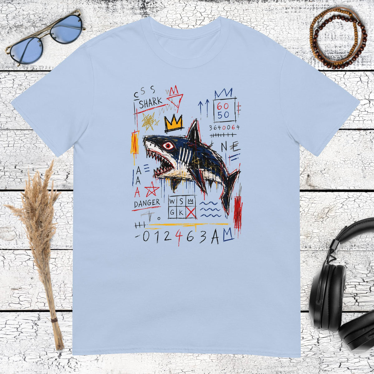 Playful crowned shark illustration with colourful graffiti elements on a light blue t-shirt