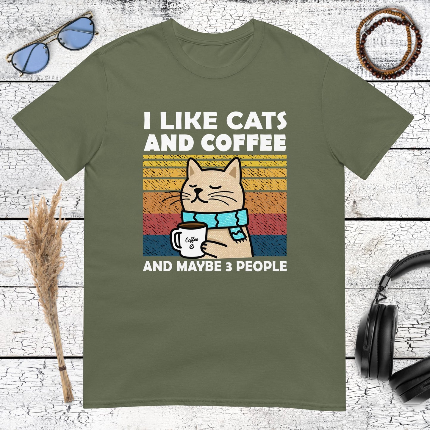 Humorous cat and coffee design with retro sunset graphic on a military green t-shirt