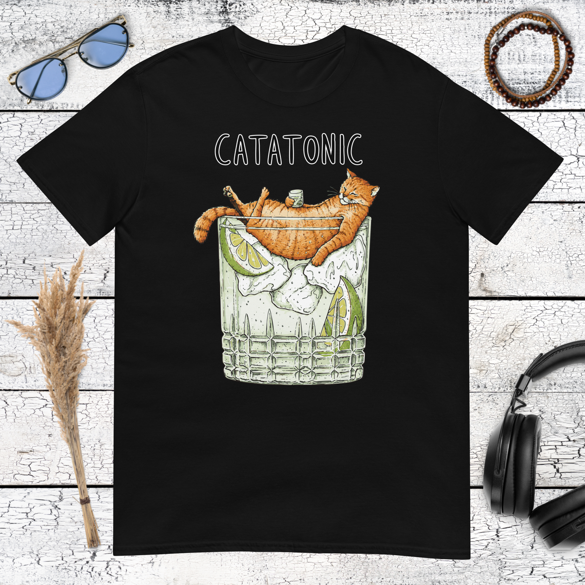 Funny orange cat holding a cocktail glass with Catatonic lettering on a black t-shirt