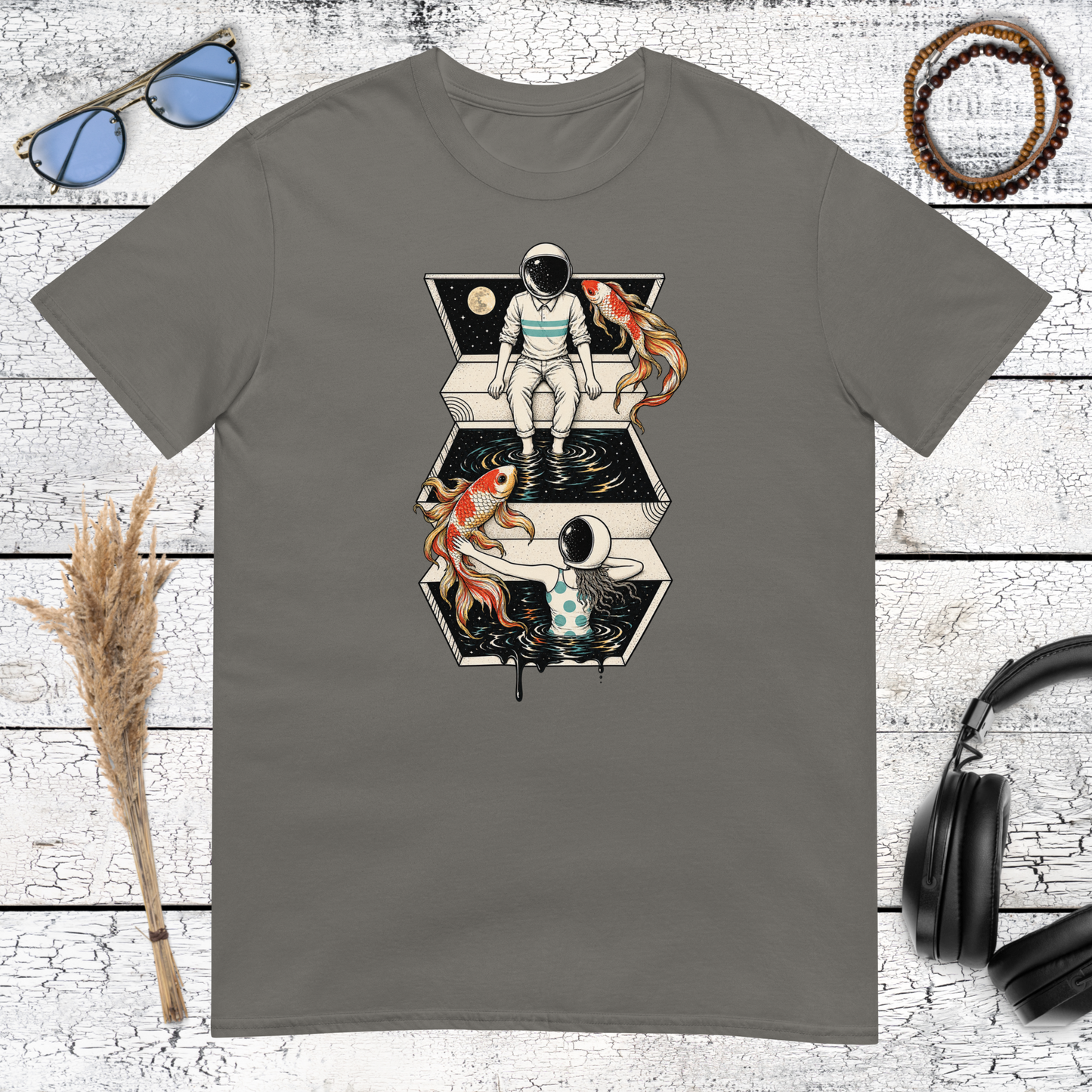 Astronaut and koi fish surreal space graphic printed on a charcoal t-shirt