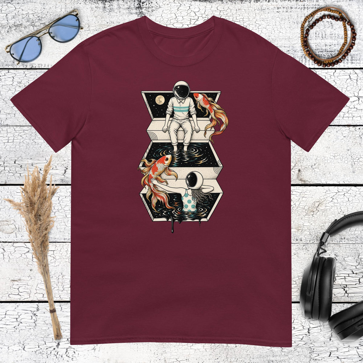 Surreal astronaut and koi fish graphic with cosmic details on a maroon t-shirt