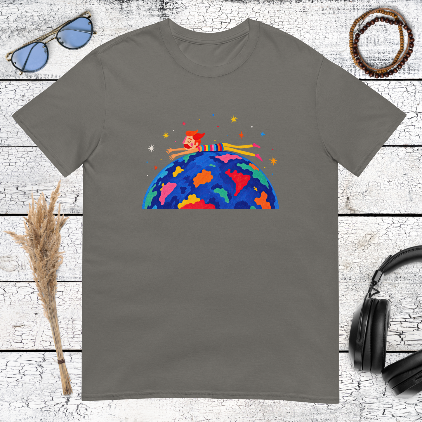 Small person riding a vibrant Earth with galaxy-inspired details on a charcoal t-shirt
