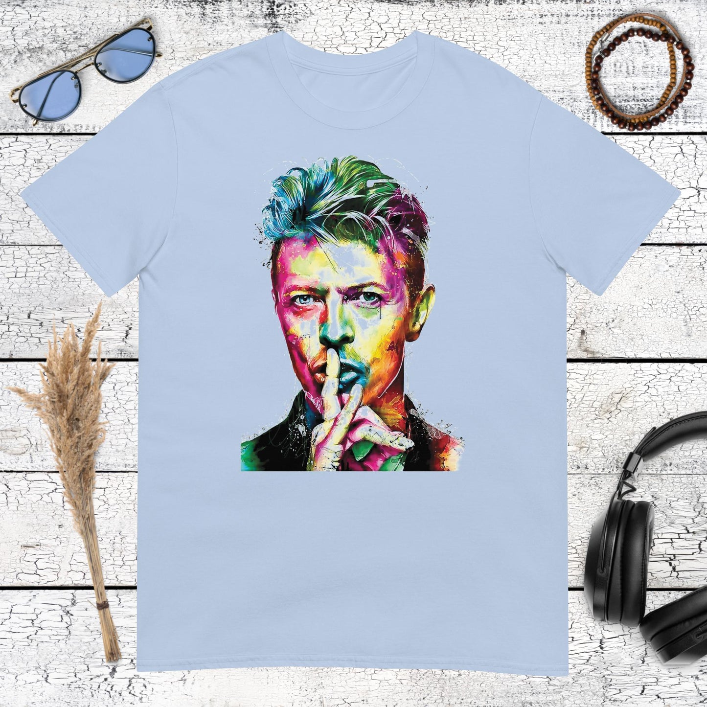 Colourful David Bowie portrait artwork printed on a light blue t-shirt