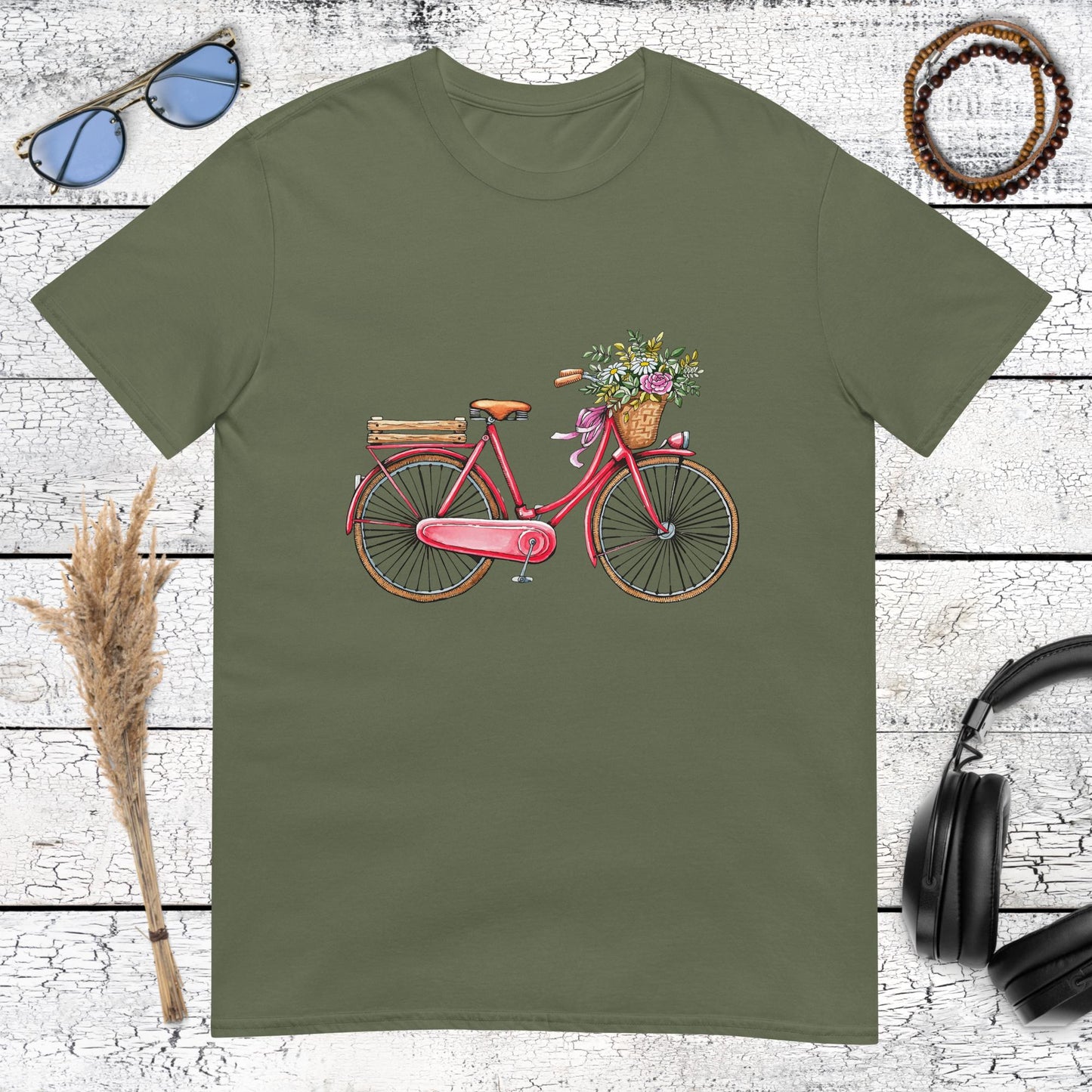 Pink vintage bicycle with a flower basket on a military green t-shirt