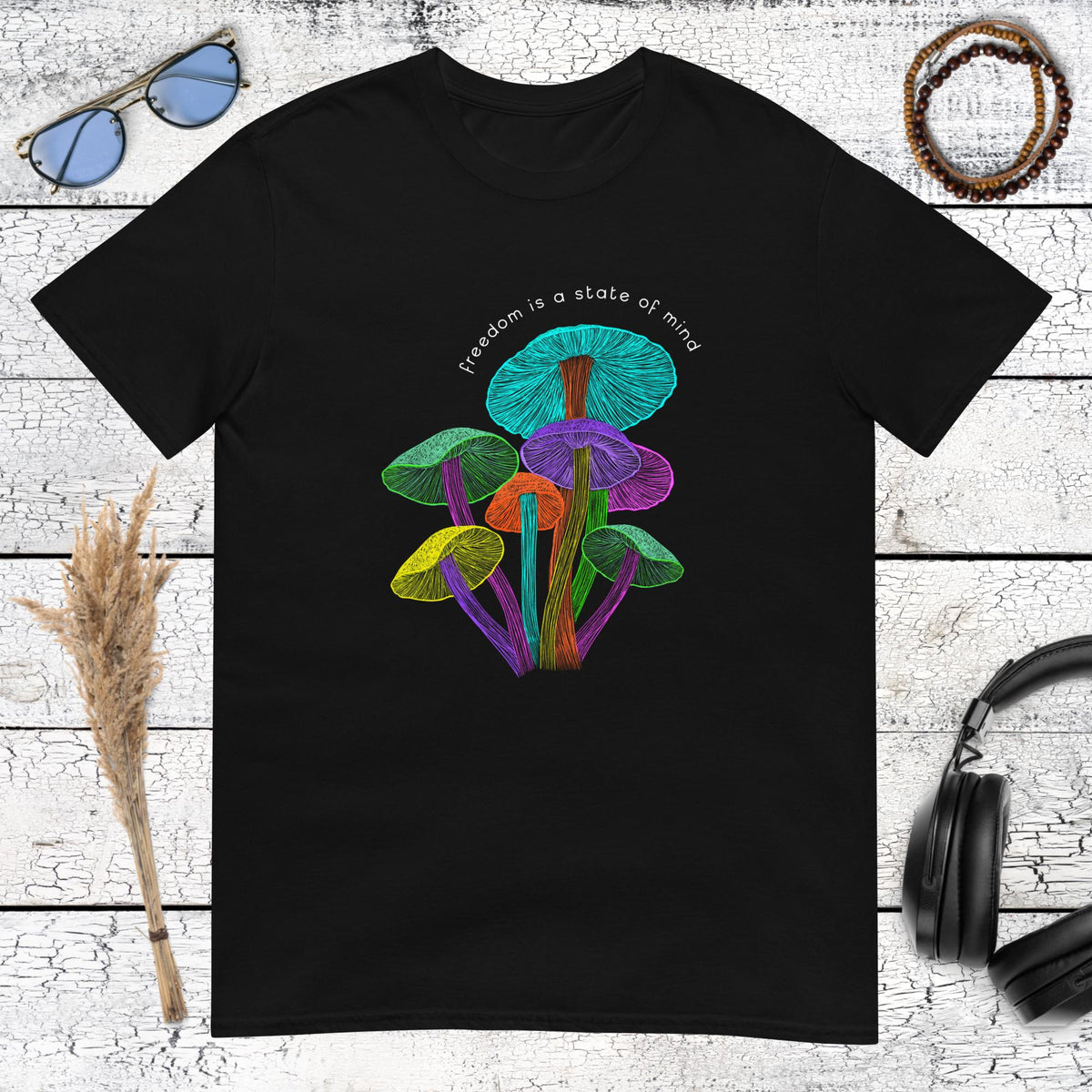 Vibrant neon psychedelic mushrooms with "Freedom is a state of mind" quote on a black t-shirt