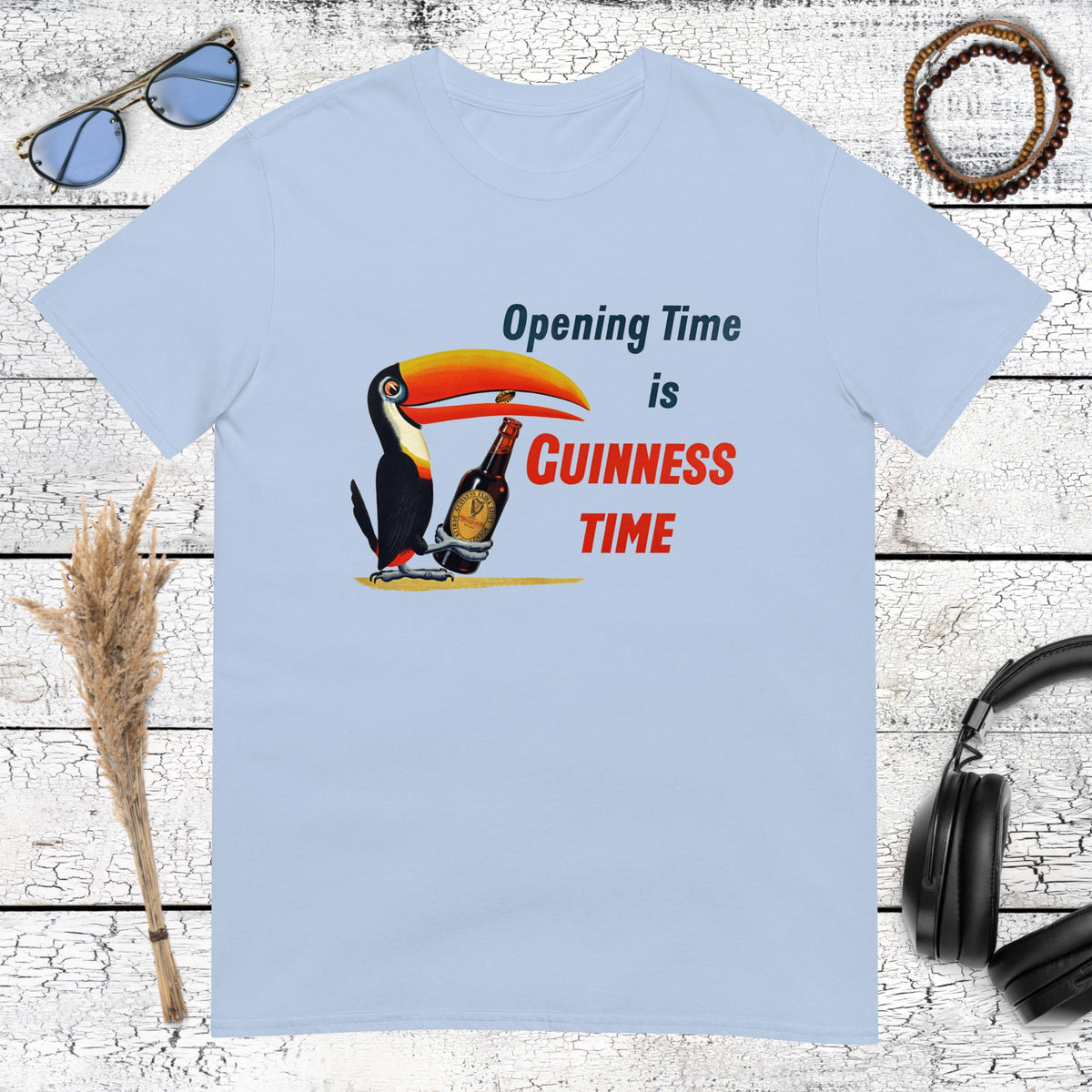 Colourful Guinness toucan holding a beer glass with Opening Time Guinness Time lettering on a light blue t-shirt