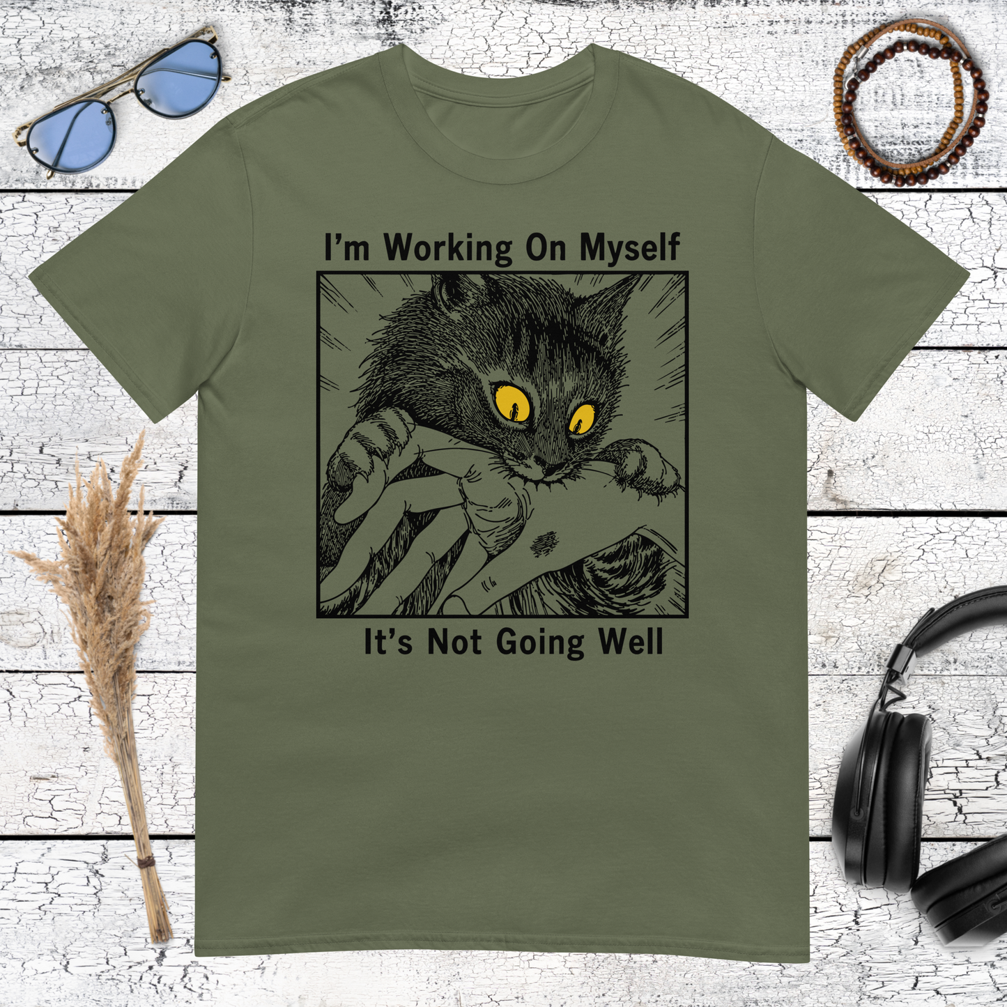Funny cat illustration with I’m Working On Myself quote printed on a military green t-shirt