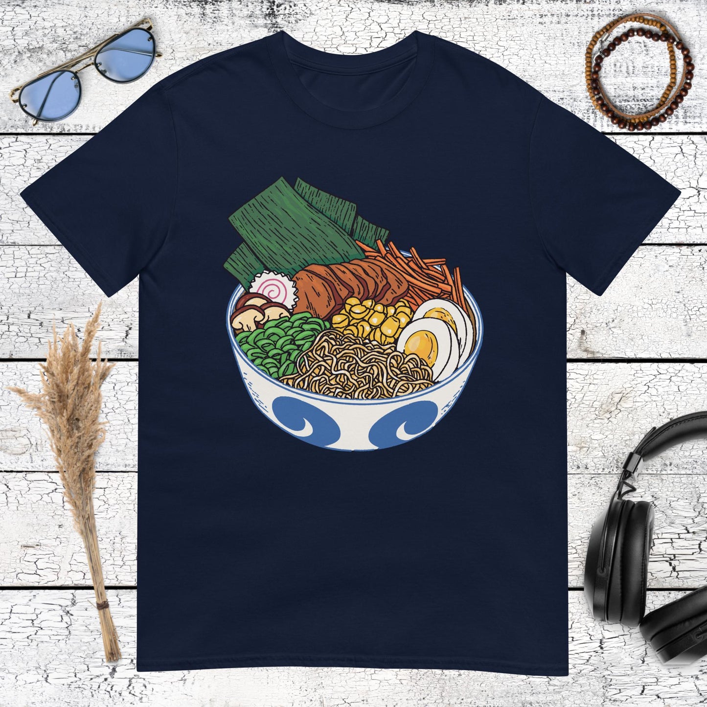 Blue patterned ramen bowl with delicious toppings on a navy blue t-shirt