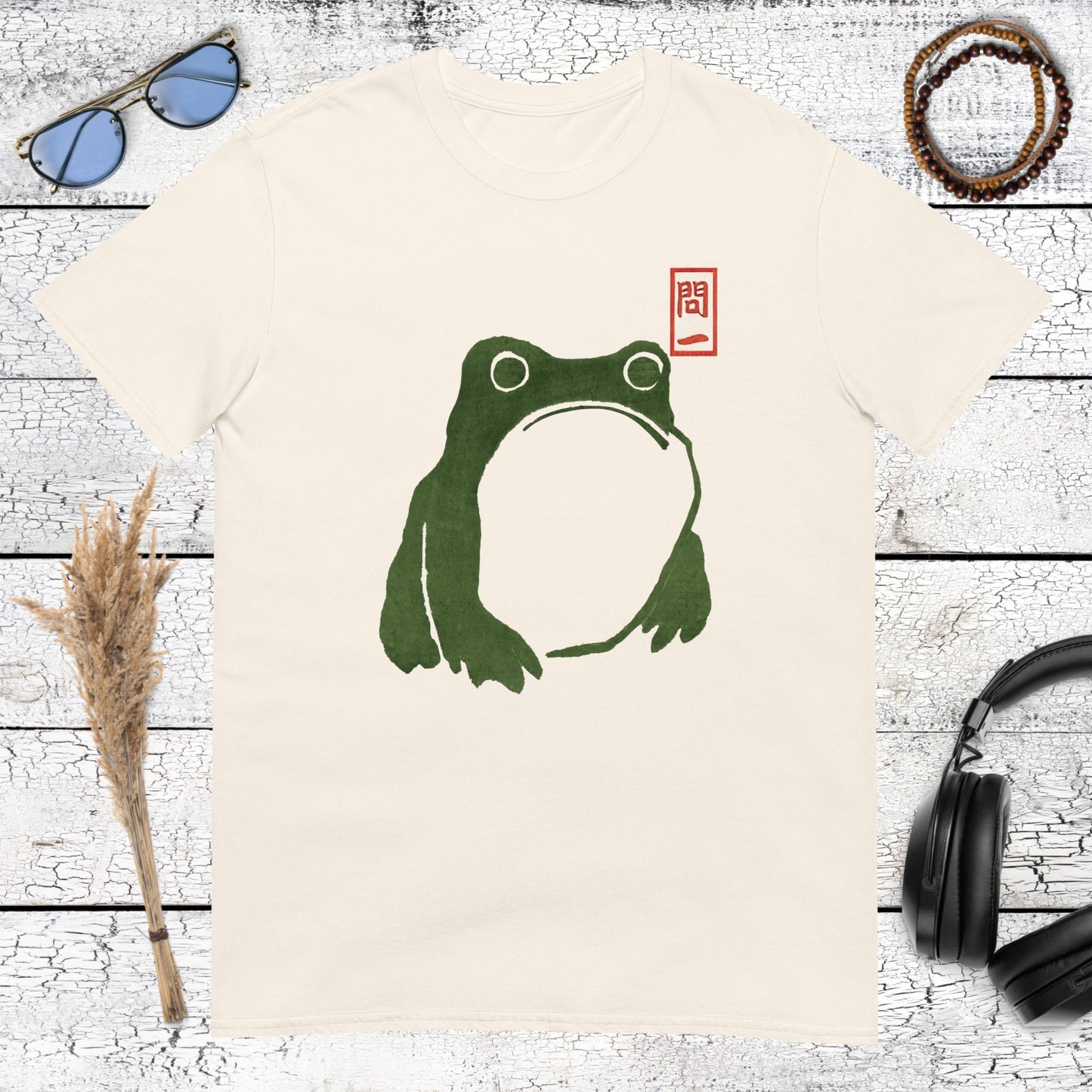 Green Japanese frog art with a red stamp detail printed on a natural cotton t-shirt