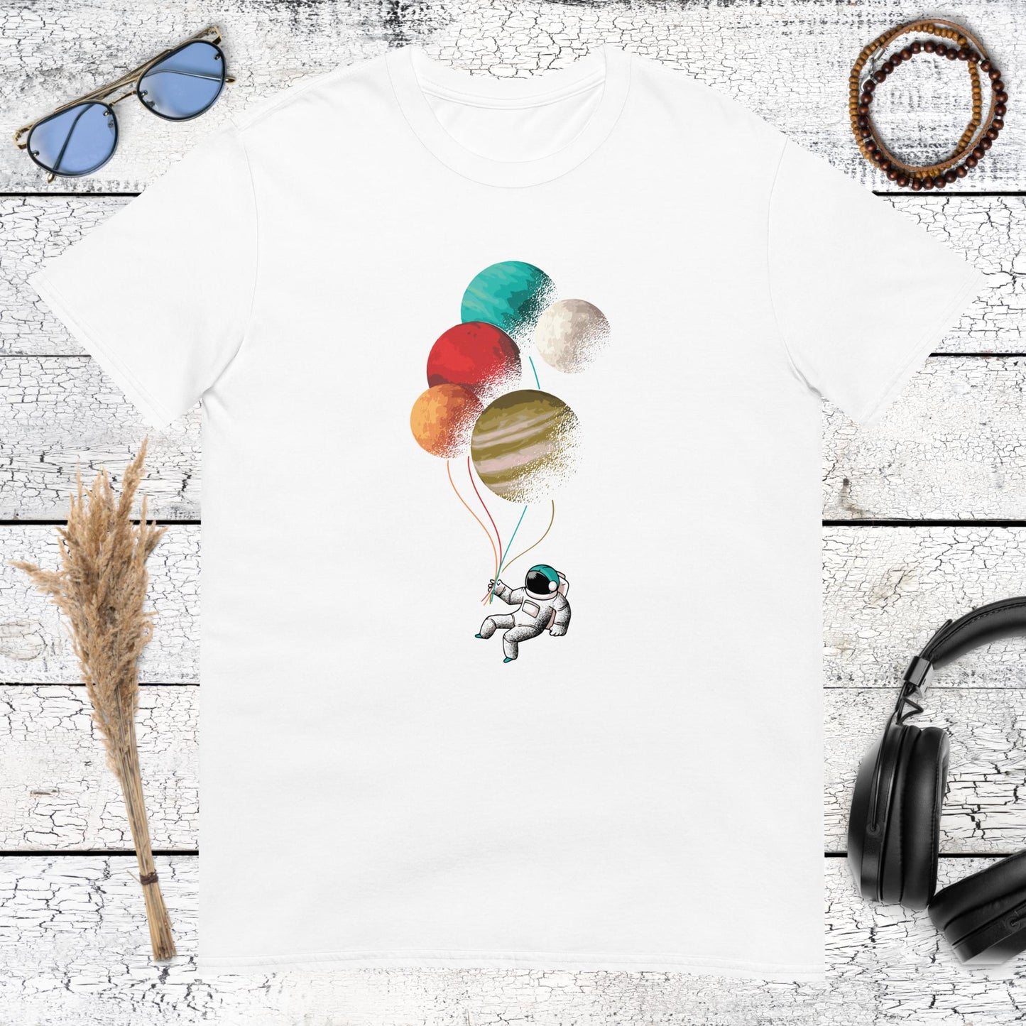 white t-shirt featuring an astronaut floating with planet balloons