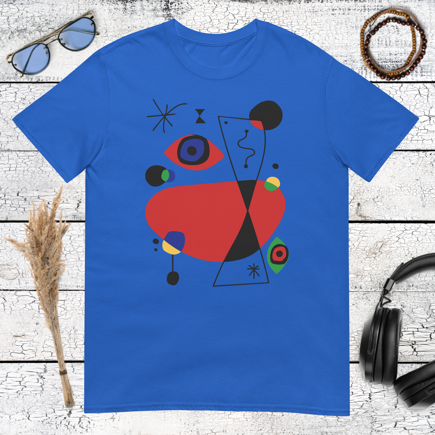 Colourful abstract art graphic with geometric shapes printed on a royal blue t-shirt