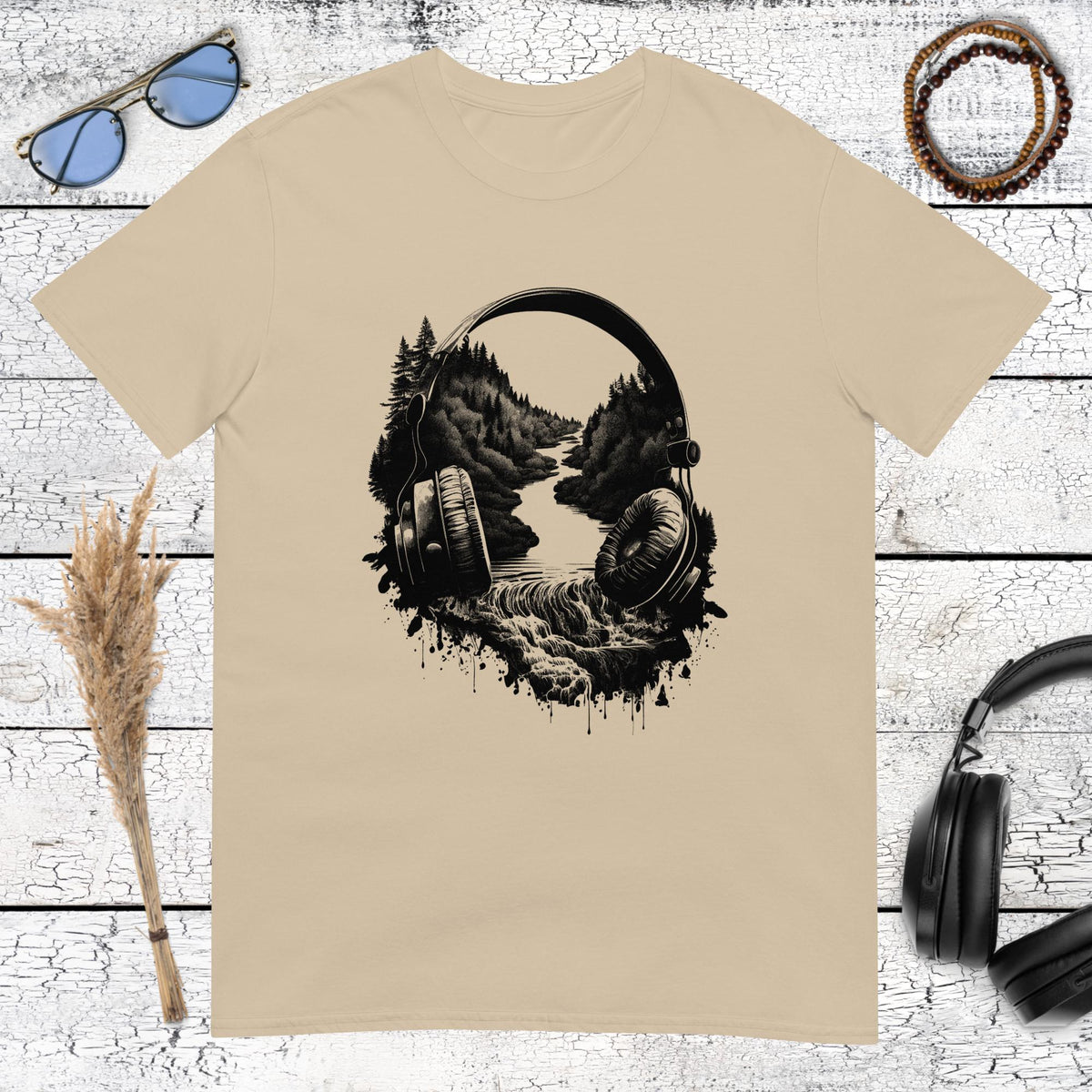 Surrealist music lover art featuring a forest landscape inside headphones on a sand coloured t-shirt