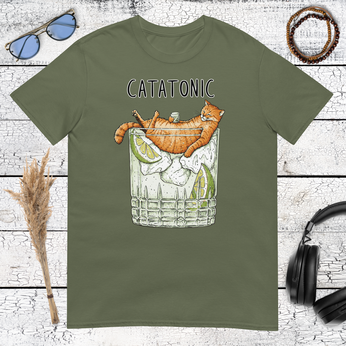 Whimsical orange cat cocktail illustration printed on a military green t-shirt