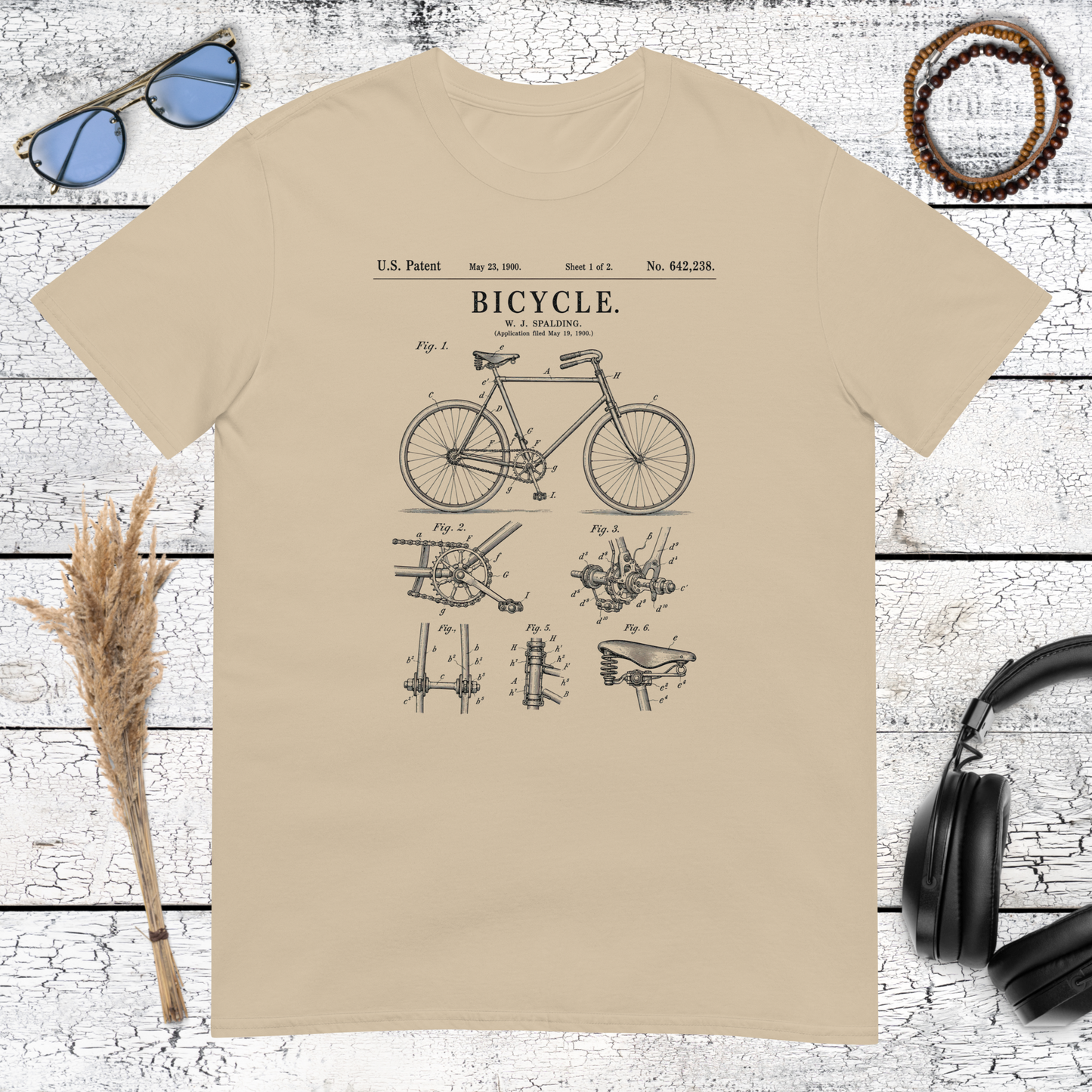 Classic bicycle graphic with vintage lettering printed on a sand t-shirt