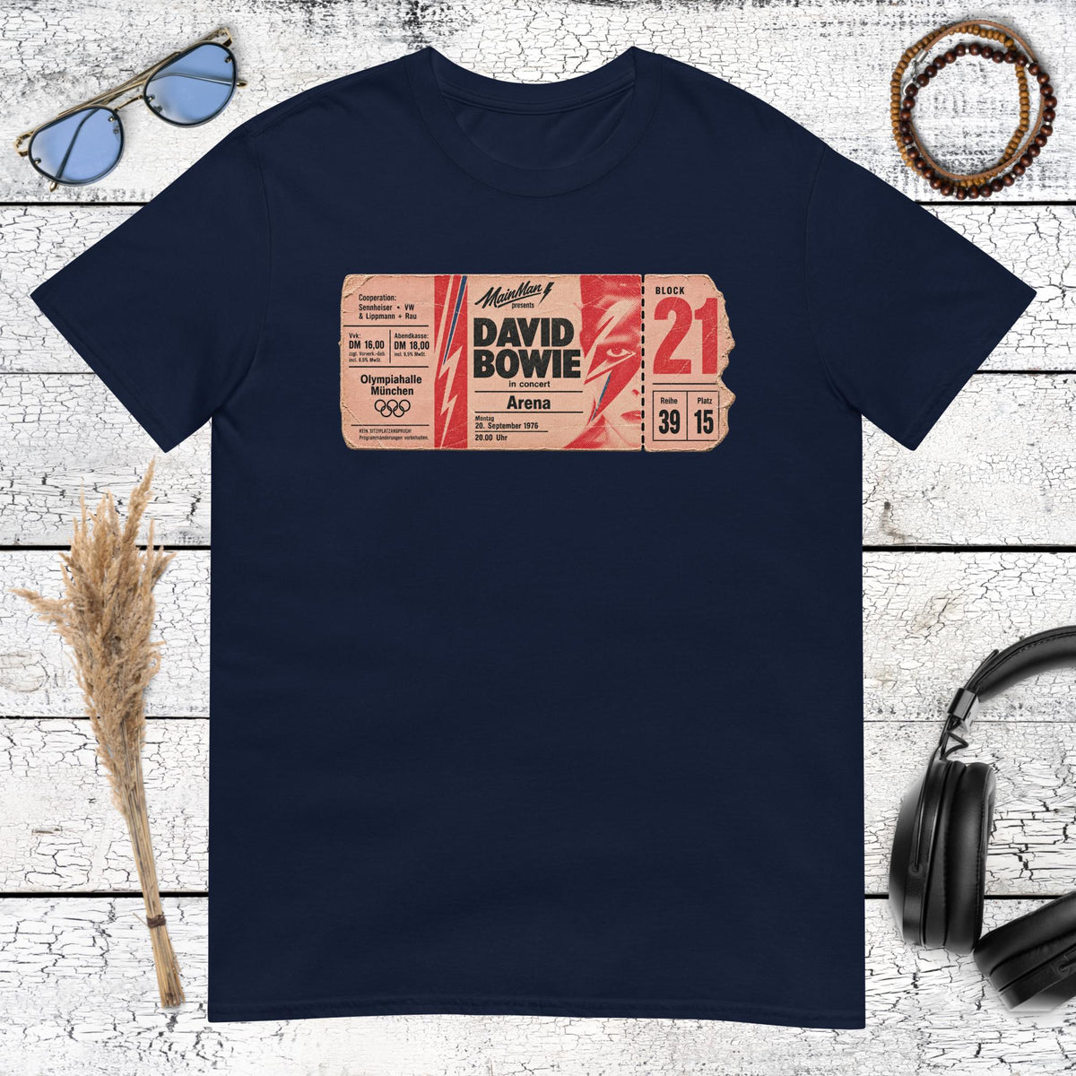 Colourful vintage typography and poster artwork printed on a navy blue t-shirt