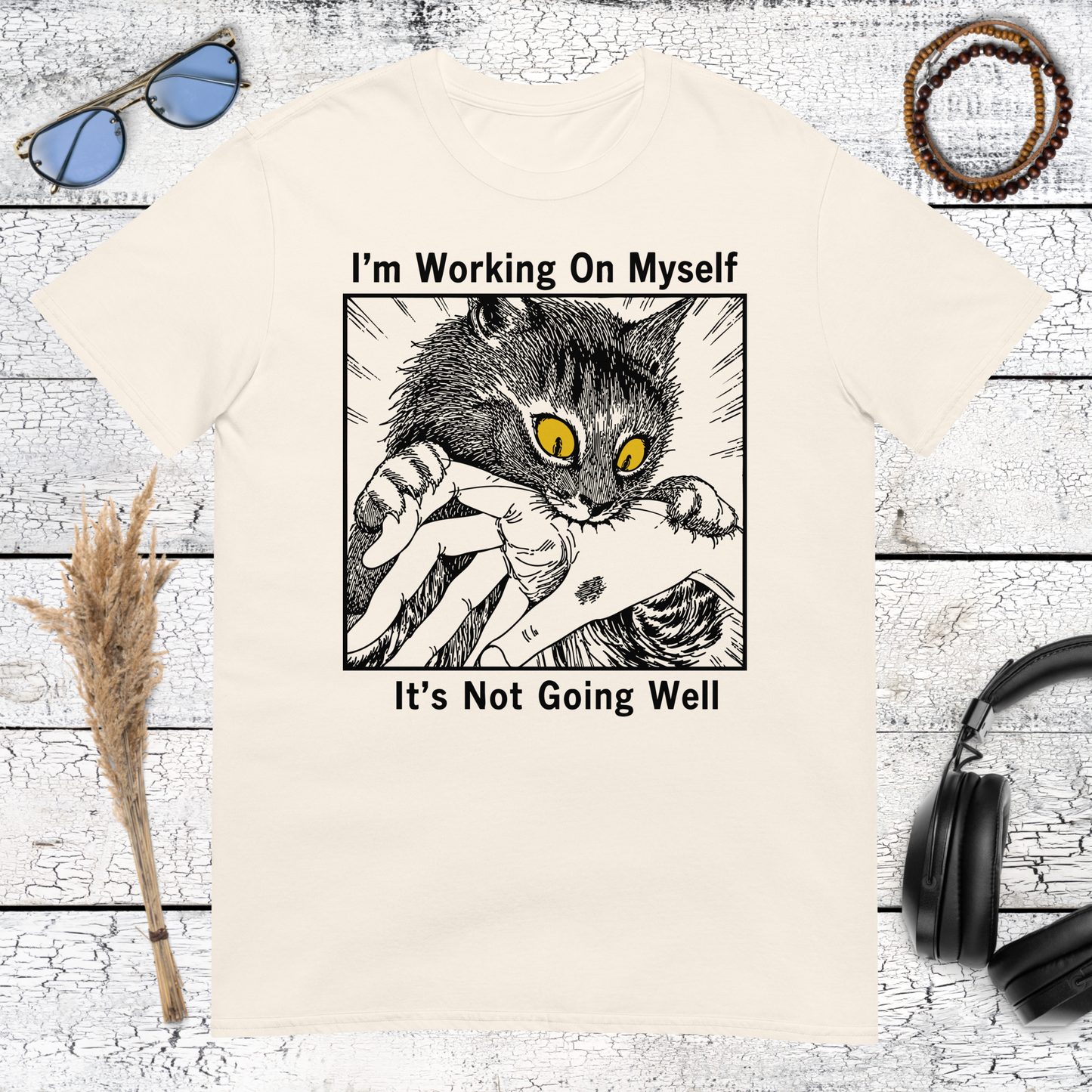Funny cat artwork with a relatable self improvement quote on a natural cotton t-shirt