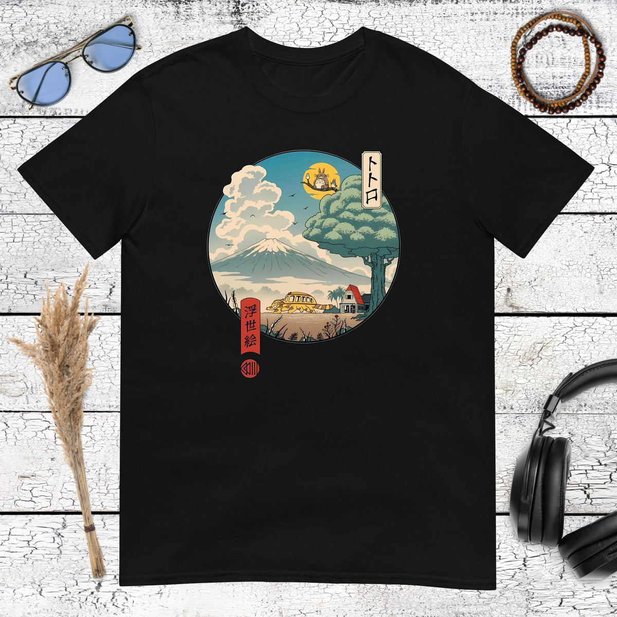 Product mockupHigh contrast Japanese art print of Totoro in a scenic landscape on a black t-shirt