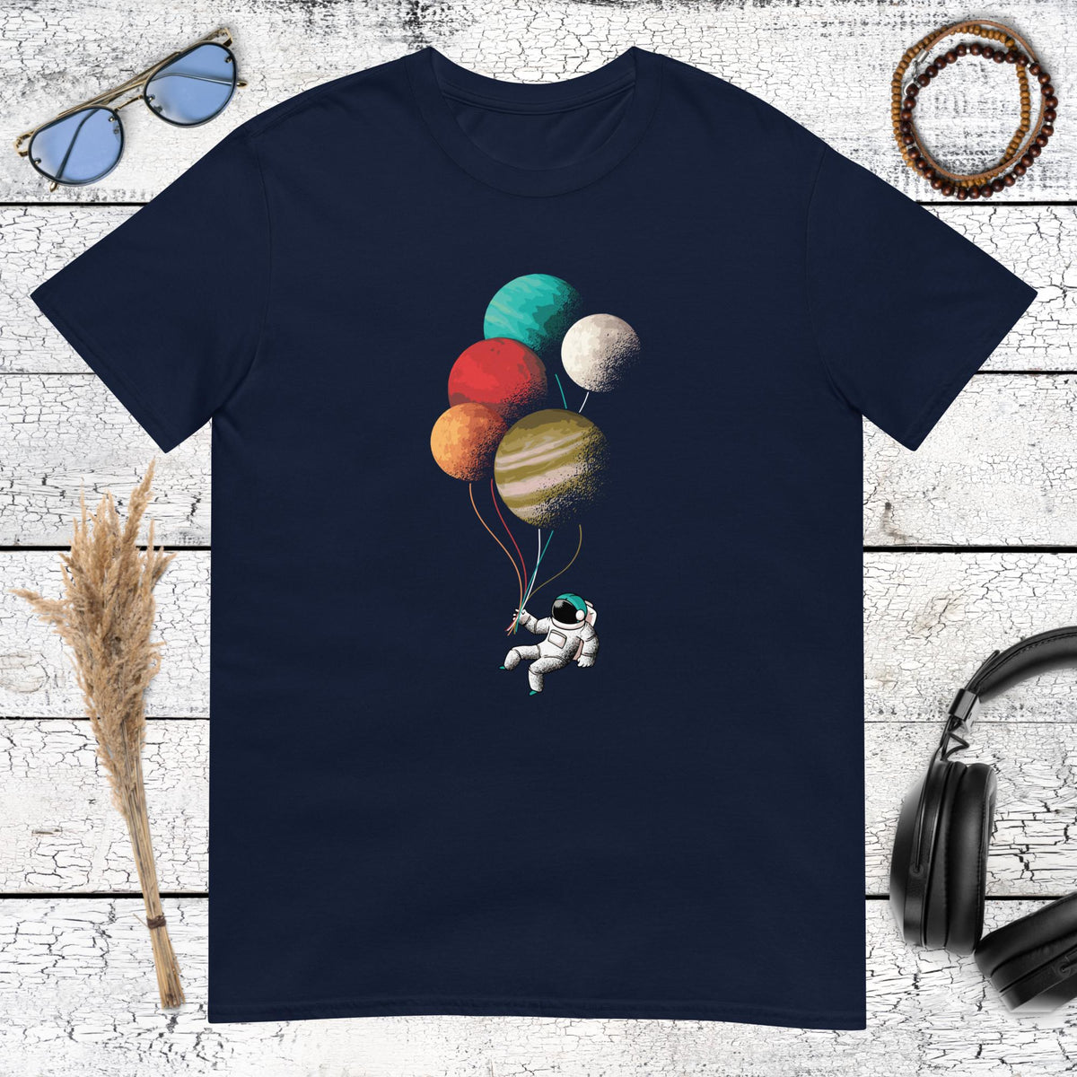 Astronaut holding celestial planet balloons graphic on navy blue shirt