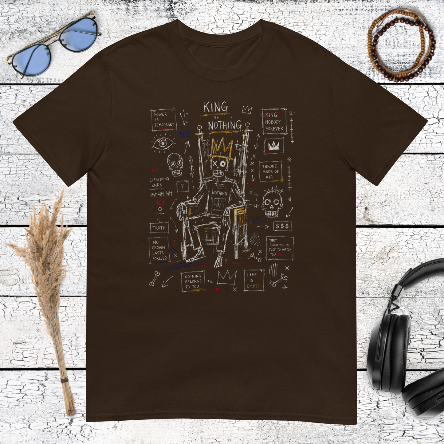 Basquiat-inspired king figure with crown and abstract graffiti details on a brown t-shirt