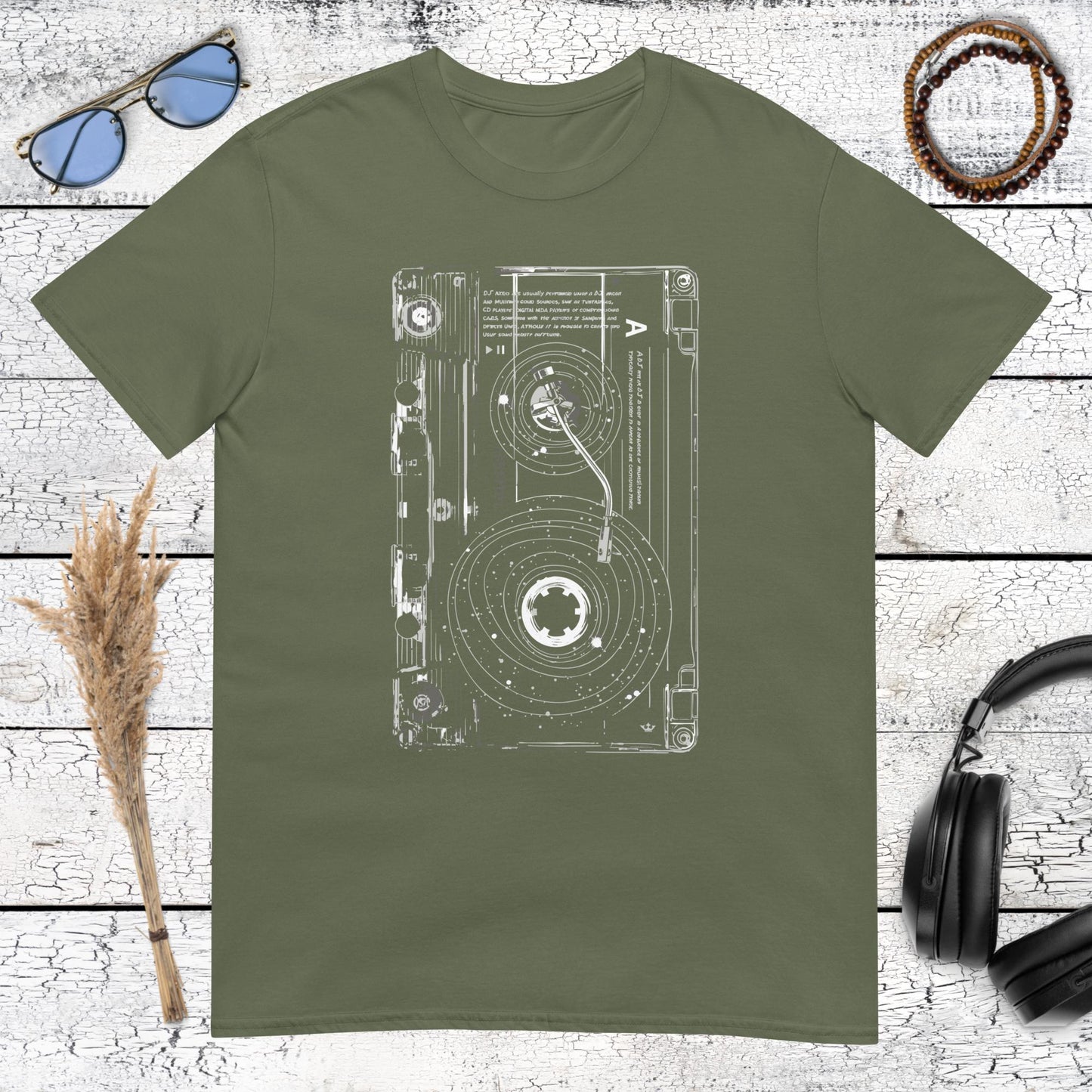 Detailed cassette tape line art drawing on military green t-shirt