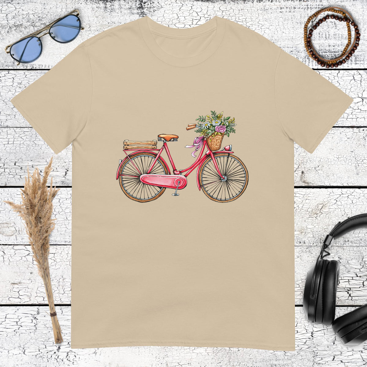 Nostalgic pink bicycle with floral details on a warm sand coloured t-shirt