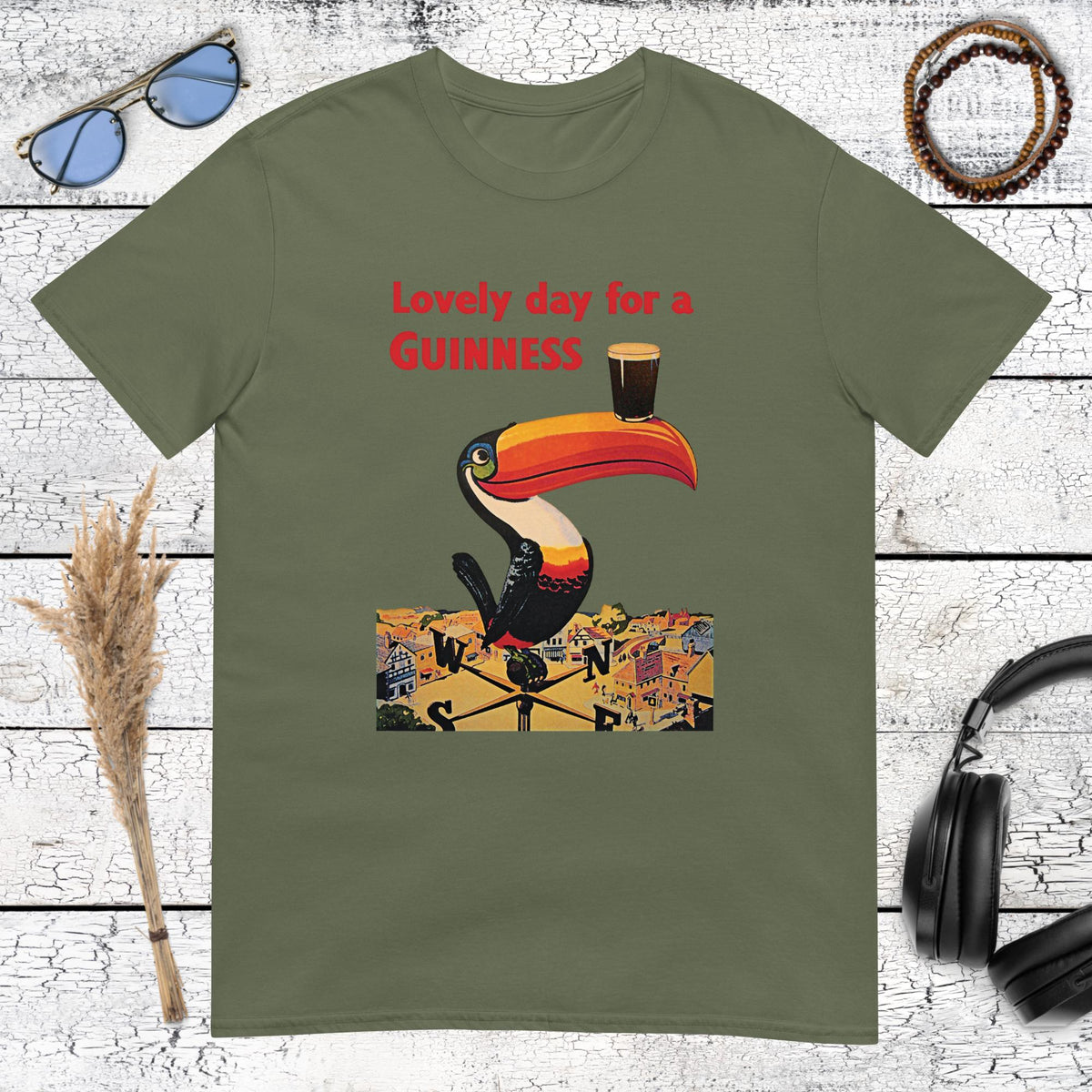 Retro Guinness toucan bird carrying a Guinness pint with vintage Guinness art on a green t-shirt