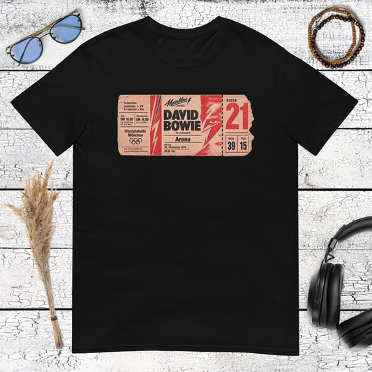 Colourful vintage music poster graphic with bold typography printed on a black t-shirt