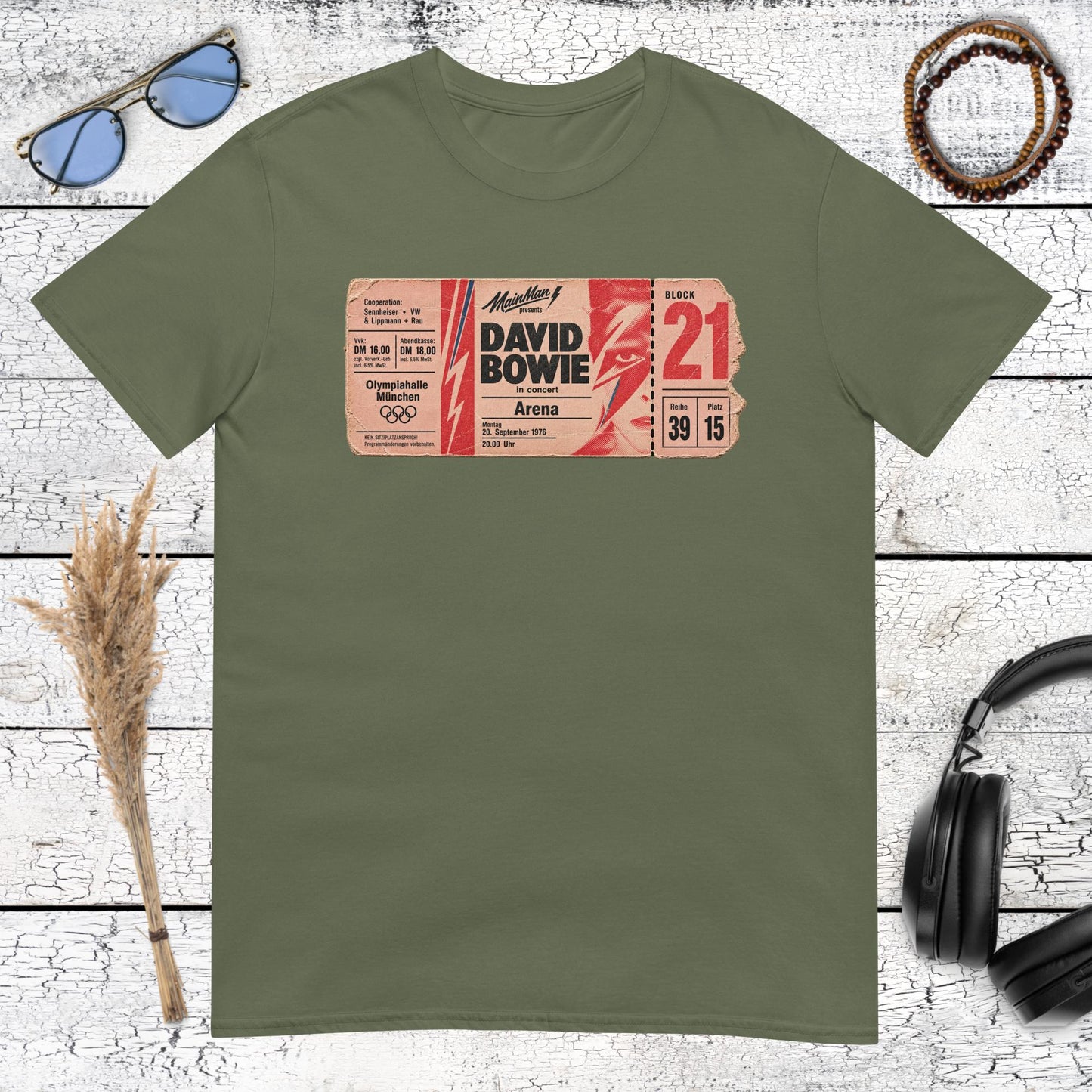 Retro music-inspired poster graphic printed on a military green t-shirt