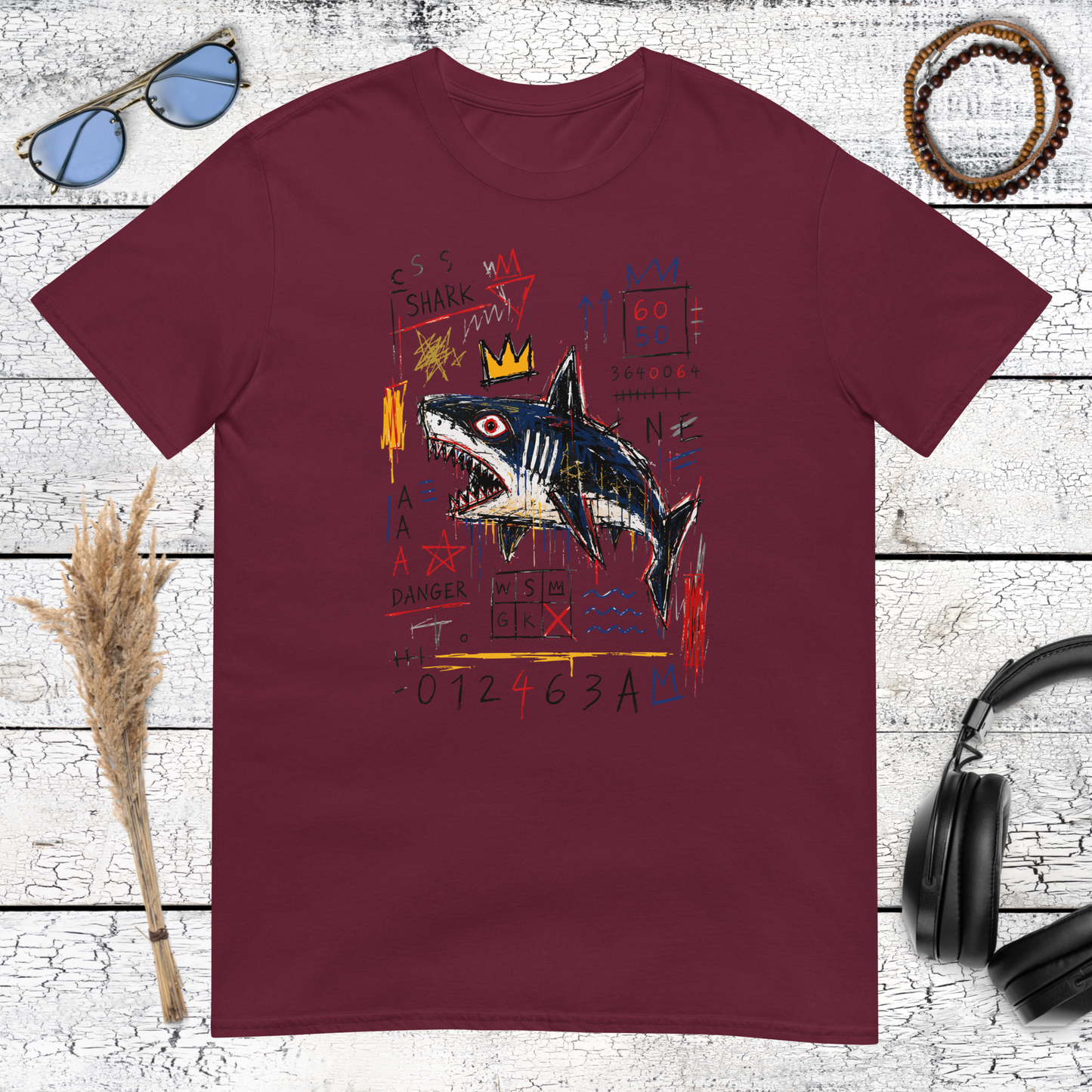 Colourful neo-expressionist crowned shark artwork printed on a maroon t-shirt